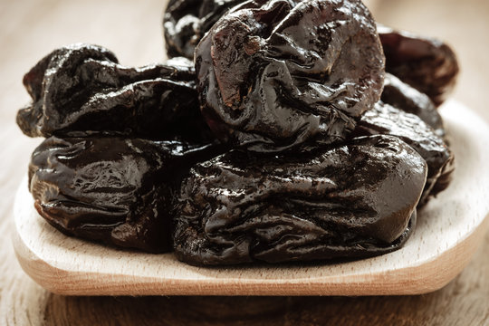 Dried Plums Prunes On Wooden Spoon