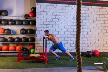 sled push man pushing weights workout