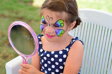 Fototapeta premium Little girl getting her face painted