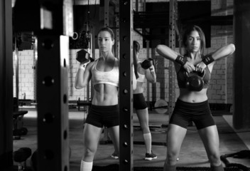 Gym women with barbell and kettlebell workout