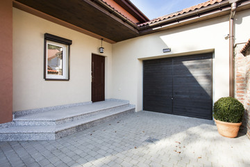 House entrance next to garage