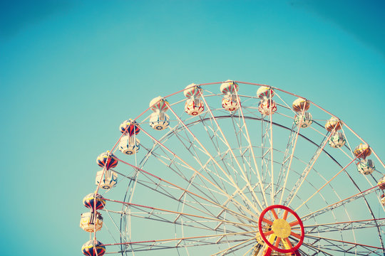 Summer ferris wheel over blue sky
