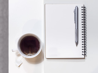 Office table with notepad and coffee cup