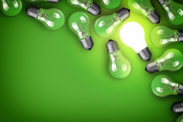 Idea concept with light bulbs on green background © chones