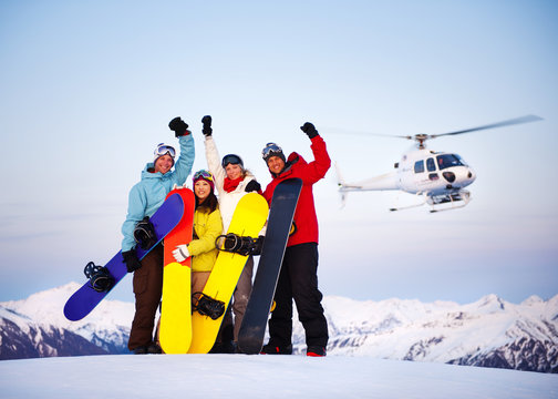 Snowboarders on Top of the Mountain with Heli Ski
