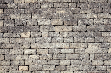Old dark gray brick wall, background texture