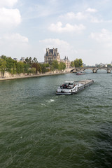 Paris - the barge  swimming with Seine toward the Royal Bridge - obrazy, fototapety, plakaty