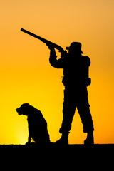 Silhouette of the hunter with a dog