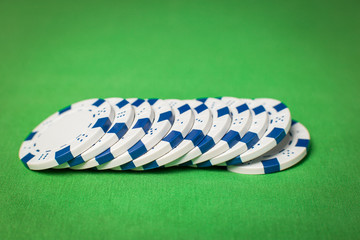 stack of poker chips on a green table