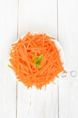 Grated carrot in bowl, top view