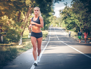 young woman jogging in the park in summer