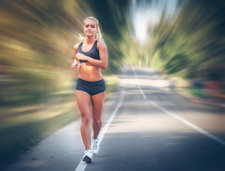 young woman jogging in the park in summer