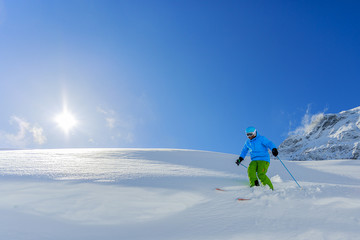 Fototapeta na wymiar Skiing, Skier, Freeride in fresh powder snow