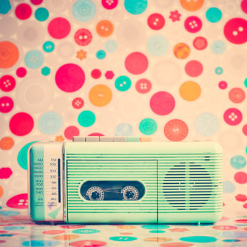 Vintage turquoise radio over colorful background