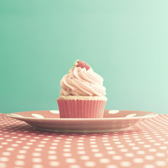 Strawberry cupcake over polka dots tablecloth