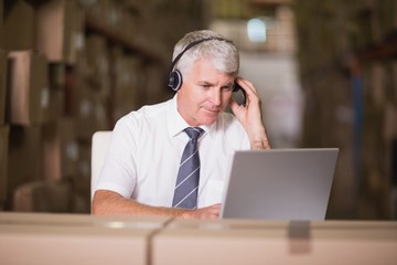 Obraz na płótnie Canvas Warehouse manager using laptop