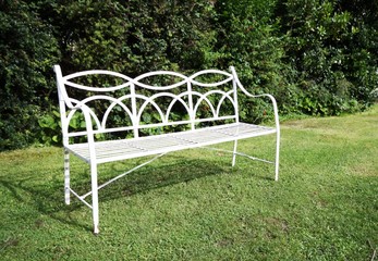 white bench in an english style garden