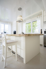 Vertical view of bright granitic kitchen island