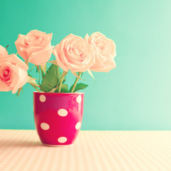 Vintage roses in a polka dots cup