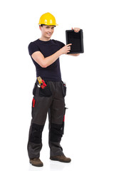 Smiling manual worker holding a digital tablet and pointing