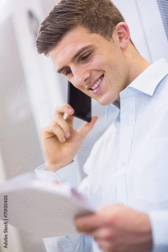 Aufkleber Smiling technician calling and reading a document