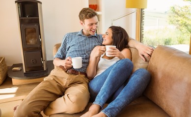 Obraz premium Happy young couple relaxing on the couch