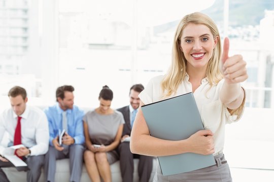 Businesswoman gesturing thumbs up