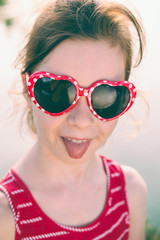 Portrait of cute little girl kid child in red sunglasses