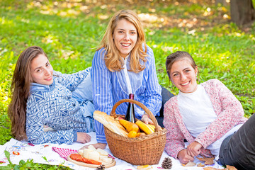 Girls laughing on picnic in nature