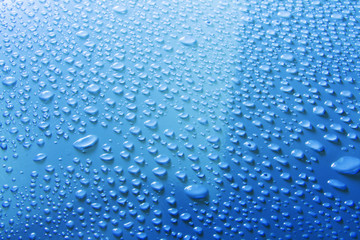 Plakat water drops on blue surface
