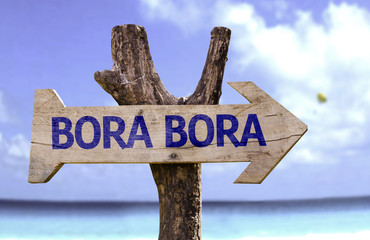 Bora Bora wooden sign with a beach on background