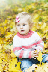 Fototapeta premium Baby girl with autumn leaves