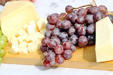 Asiago cheese and black grapes and white grape