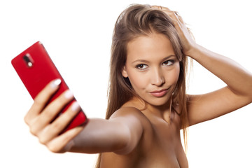 smiling young girl takes a selfie