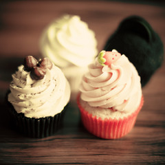 Vintage cupcakes over wood background