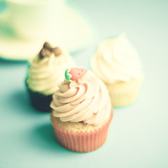 Vintage cupcakes over blue background