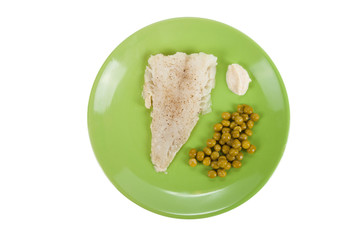 cod fillet with green peas and horseradish sauce on a green plat