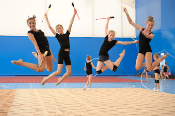 Girls with Indian clubs during high jump