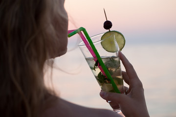 Woman drinking mojito cocktail