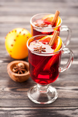 Two glasses of mulled wine with spices and orange
