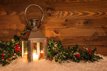 Christmas lantern in snow and holly © RTimages
