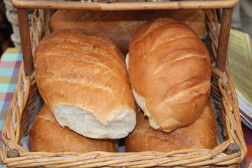 A Wicker Basket of Freshly Baked Bread Loaves.