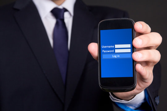 Mobile Phone With Login Screen In Business Man Hand