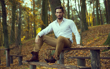 Fashion model posing in autumn scenery