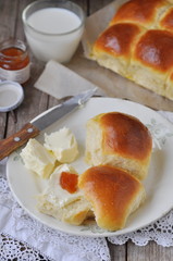 Homemade dinner rolls with butter and jam, selective focus