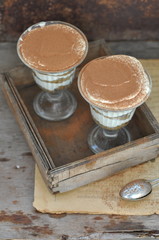 Italian dessert Tiramisu in glasses, selective focus
