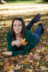 Woman lying in autumnal park