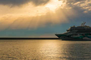 cruise ship in a cloudy sunset