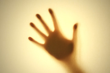 Silhouette of a hand, yellow background