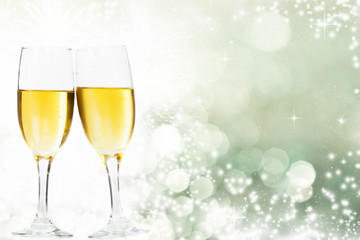 Glasses with champagne and clock close to midnight